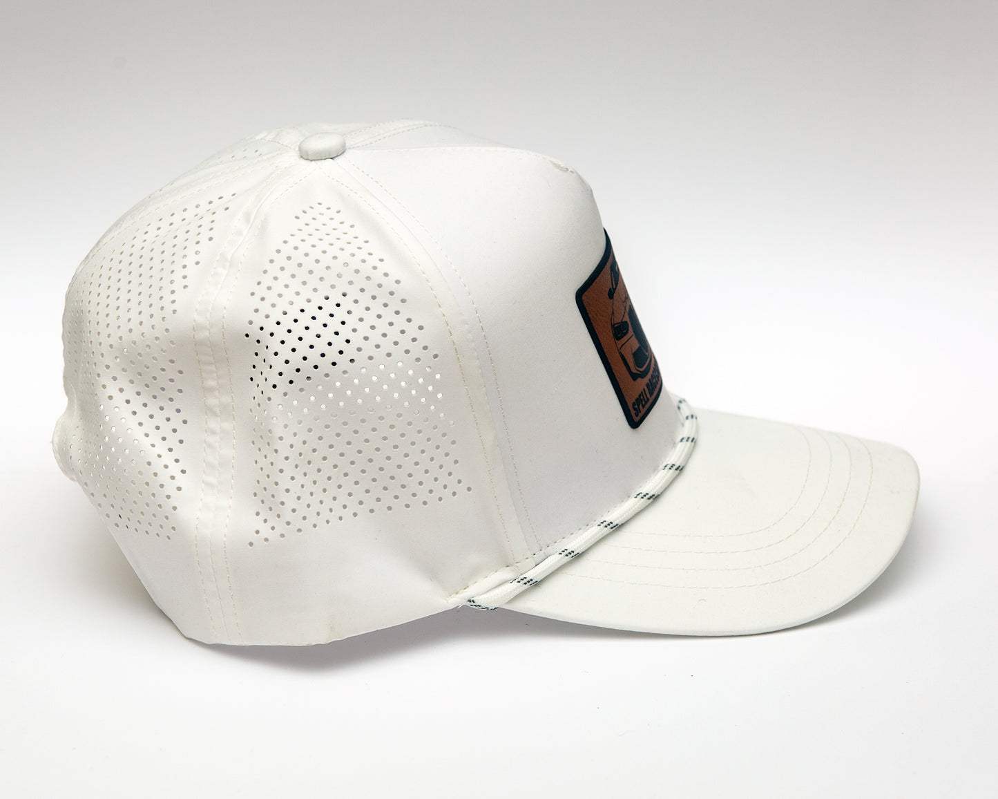 side view of black ball cap with leather patch with front view illustration of car, photographed on white background