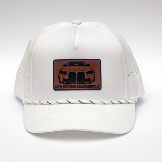 front view of white ball cap with leather patch with front view illustration of car, photographed on white background